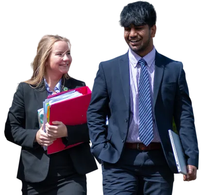 two wrekin sixth students walking side by side carrying books and folders